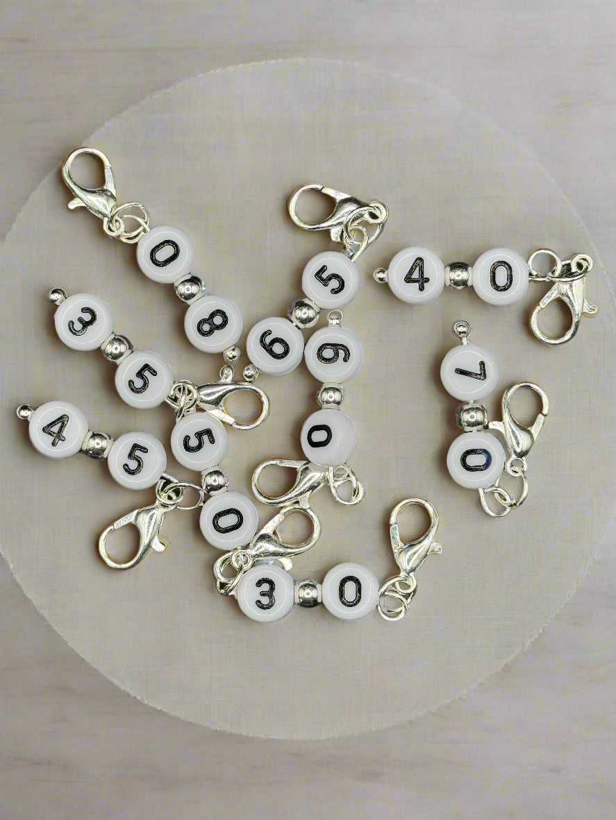 Set of number-themed hook minders on a gray background